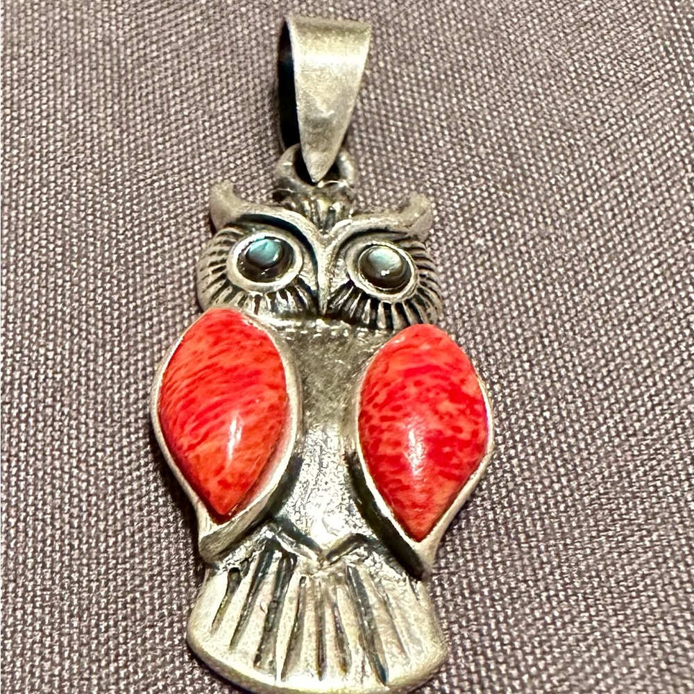 Brand new sterling silver owl charm with red coral wings and abalone eyes.